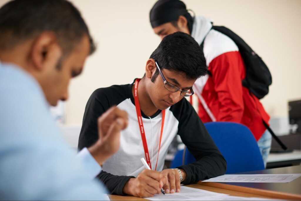 Class 11 student preparing for JEE 2028 with textbooks and study notes